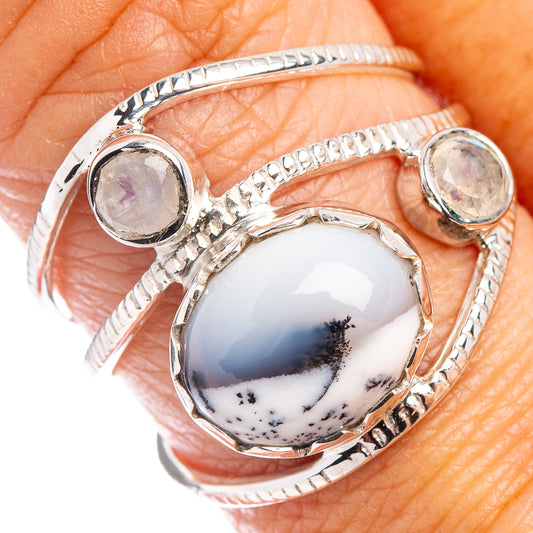 Sterling silver dendritic opal ring with oval white-blue cabochon and bezel prongs