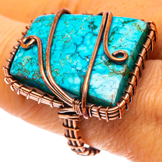 Turquoise gemstone and oxidized copper ring, close-up on finger with wire details