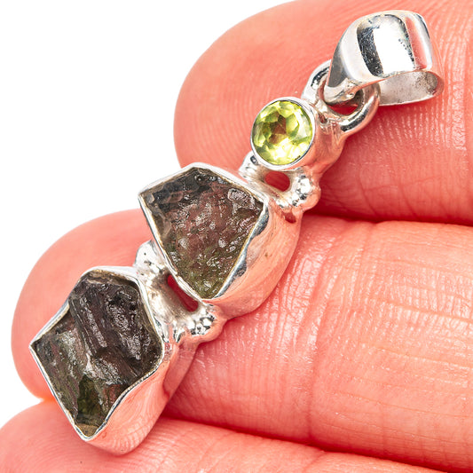 Sterling silver peridot and moldavite pendant with round green gemstone and dark stone pieces