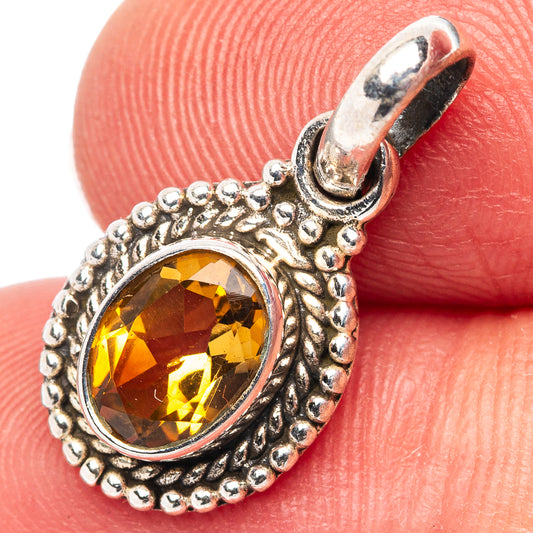 Citrine gemstone pendant in detailed silver frame, hinged bail at top