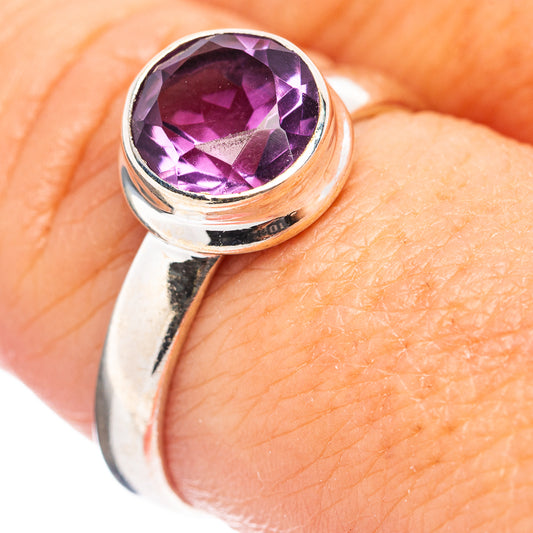 Sterling silver amethyst ring with round purple gemstone, close-up setting