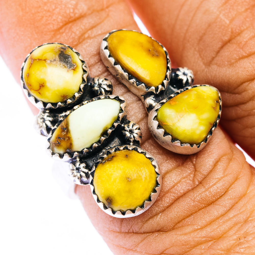 Sterling silver ring with oval yellow and white cabochon stones in ornate settings