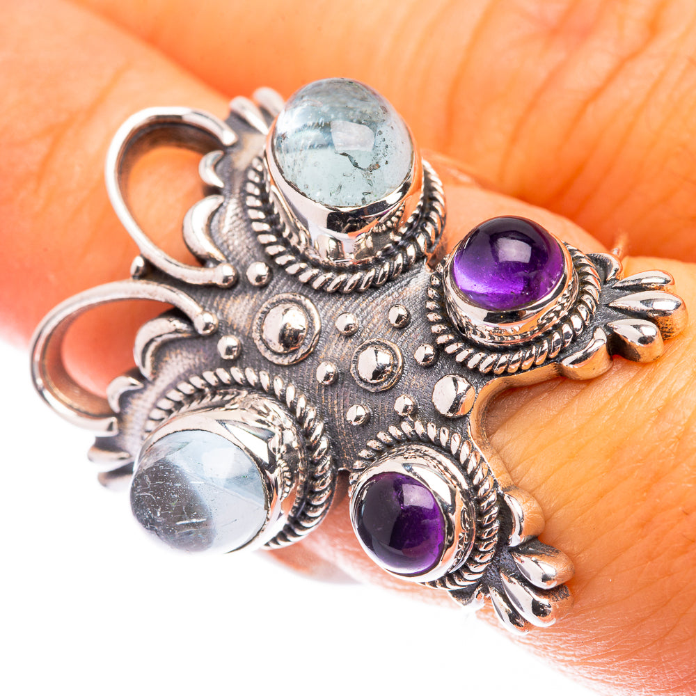 Ornate sterling silver ring with blue aquamarine and purple amethyst gemstones