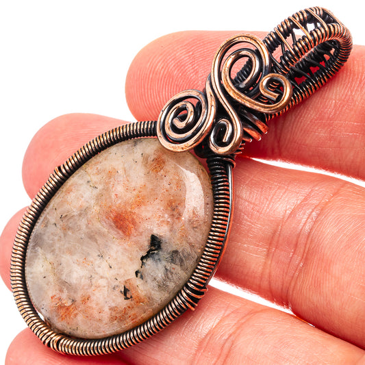 Oxidized copper wire wrap pendant with oval stone and coiled wire frame