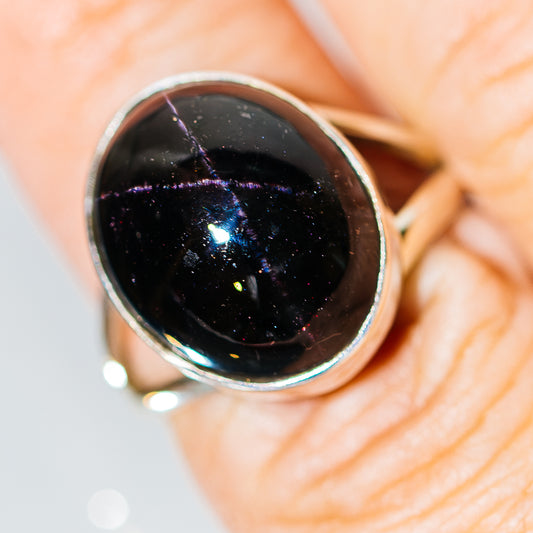 Sterling silver ring with dark starburst gemstone bezel setting