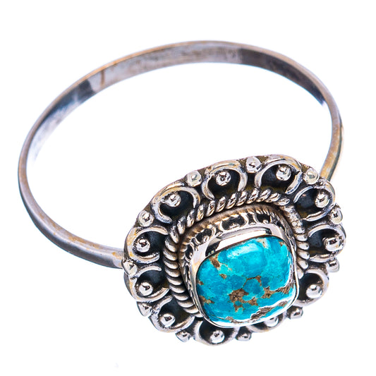 Turquoise cabochon dainty ring with ornate silver bezel, angled view showing band