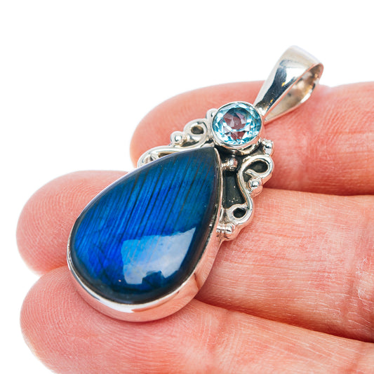 Sterling silver pendant: blue labradorite teardrop with round blue topaz bezel