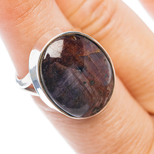 Sterling silver ring with oval dark red cabochon gemstone, bezel setting