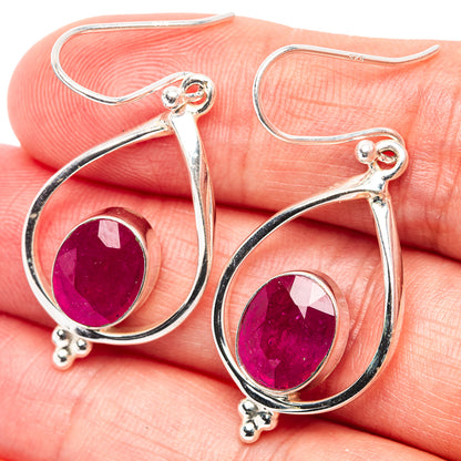 Sterling silver teardrop earrings with ruby-red faceted glass centers and hook backs