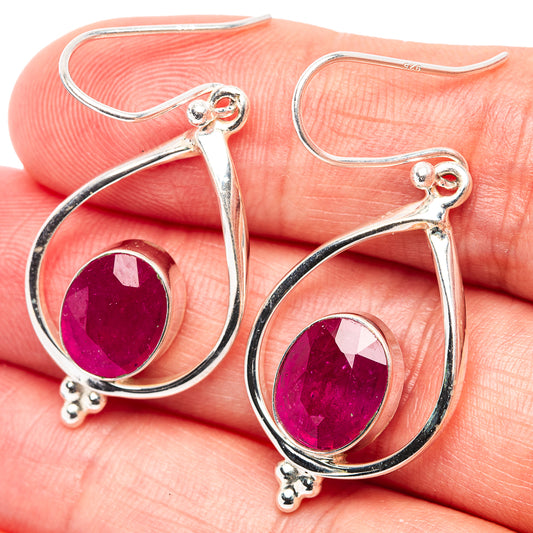Sterling silver teardrop earrings with ruby-red faceted glass centers and hook backs