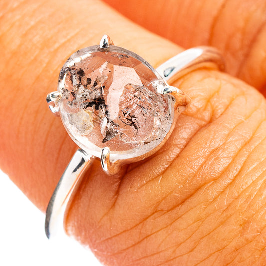 Sterling silver ring with faceted cacoxenite stone and prongs, close-up