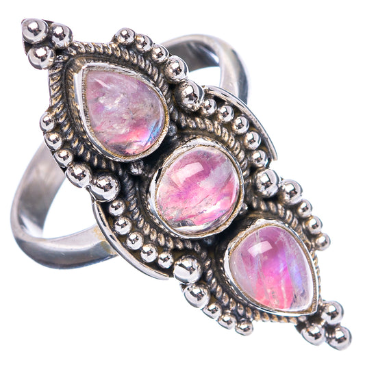 Sterling silver ring with three pink teardrop cabochons in ornate border setting