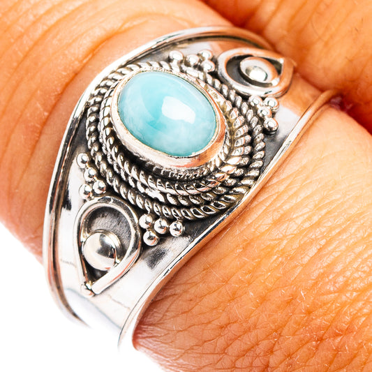 Sterling silver cocktail ring with oval light-blue larimar stone, ornate bead setting