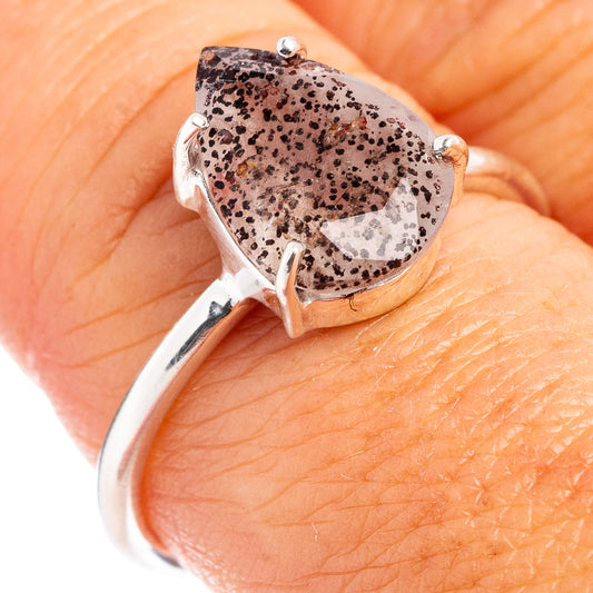 Sterling silver ring with oval purple speckled stone in prong setting