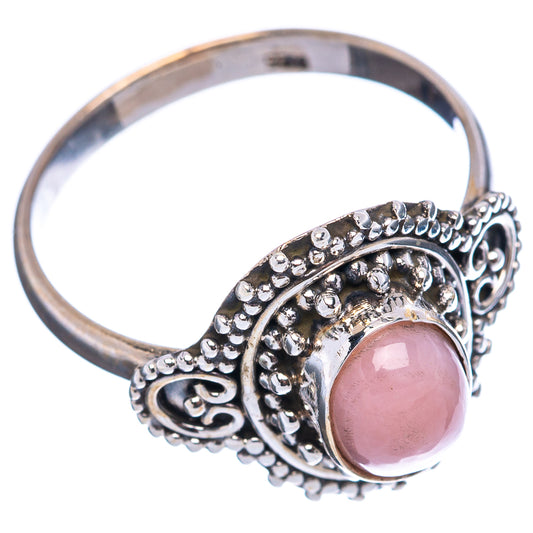 Pink oval stone sterling silver ring with detailed filigree and openwork band side view