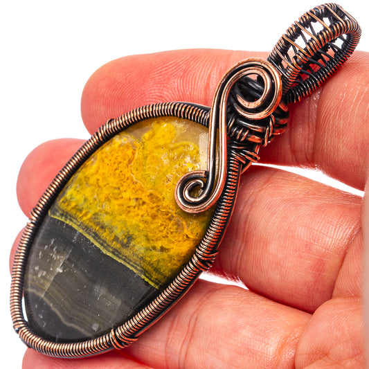 Oxidized copper wire-wrap jasper pendant with oval stone, yellow and dark bands