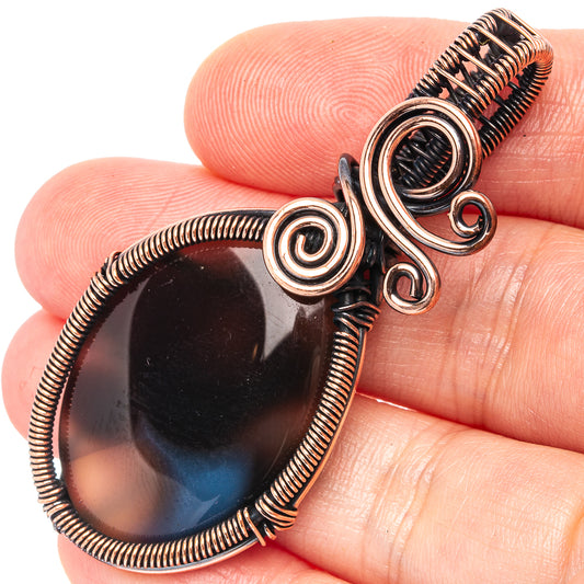Banded agate wire wrap pendant, oxidized copper with dark blue oval cabochon