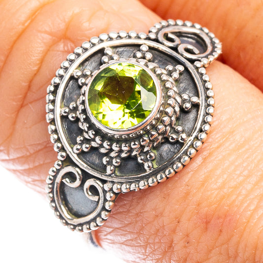 Sterling silver peridot ring with round green gemstone, ornate bezel and bead borders