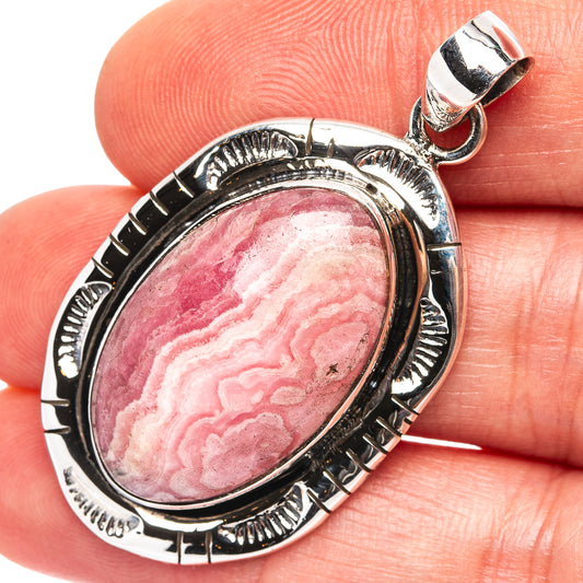 Oval rhodochrosite pendant in .925 sterling silver bezel with bail loop