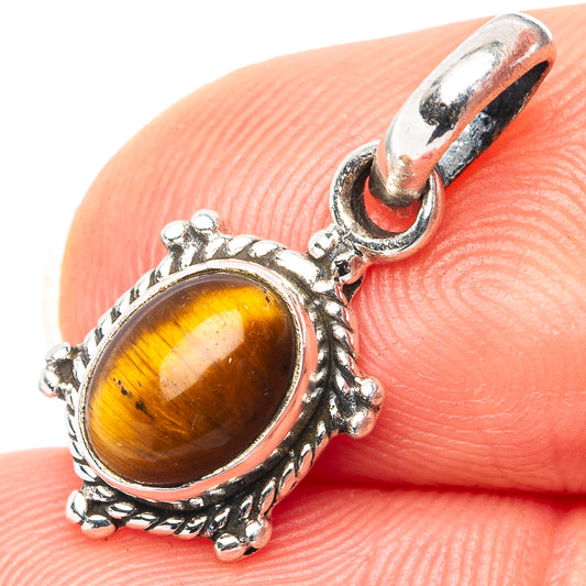 Oval tiger's eye pendant, .925 sterling silver with ornate bezel and loop bail.