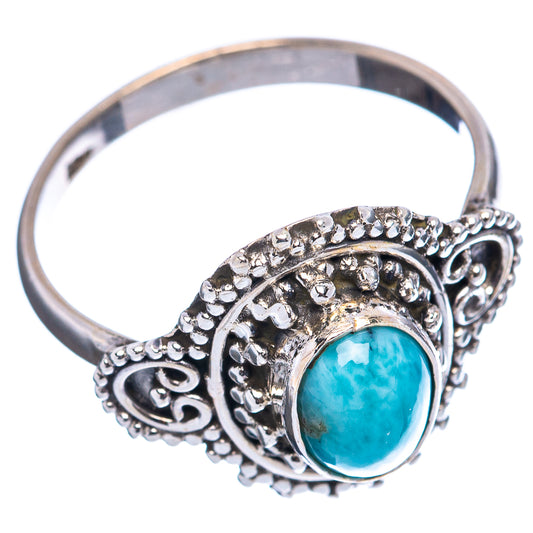 Sterling silver Larimar oval ring with raised bezel and decorative scrollwork, side view
