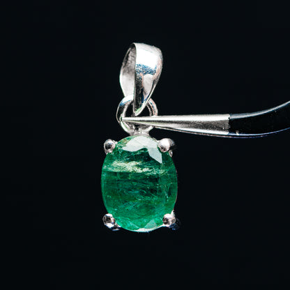 Sterling silver emerald pendant with faceted green gemstone and prong setting