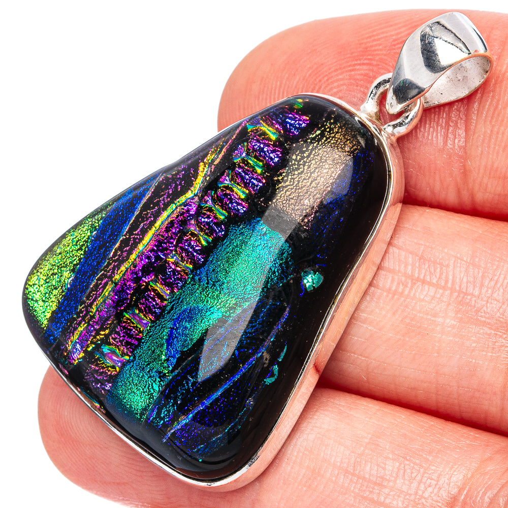 Dichroic glass pendant with iridescent dark blue, purple, and green finish on silver bail