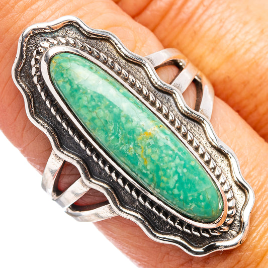 Turquoise oval sterling silver ring with ornate scalloped bezel and blackened frame