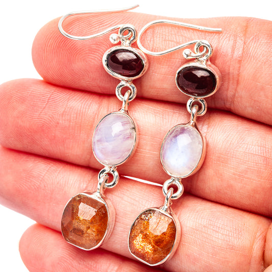 Sterling silver dangle earrings with red, opalescent white and orange gemstones