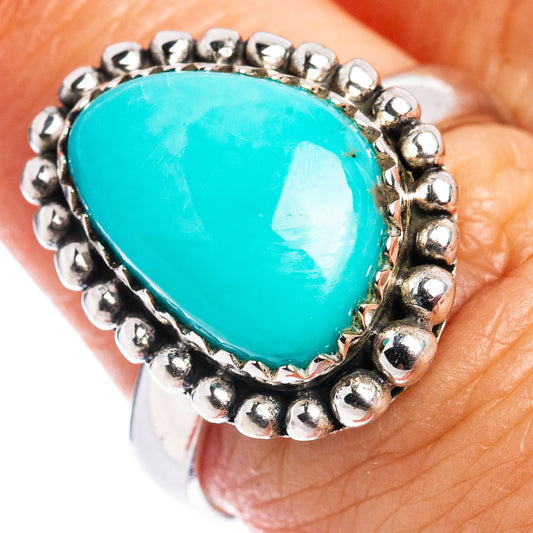 Sterling silver turquoise ring with oval turquoise cabochon and beaded halo