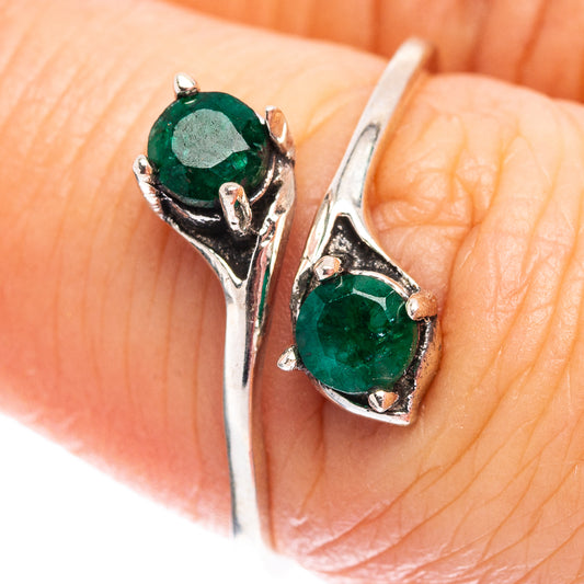 Sterling silver ring close-up with two green gemstones in prong settings