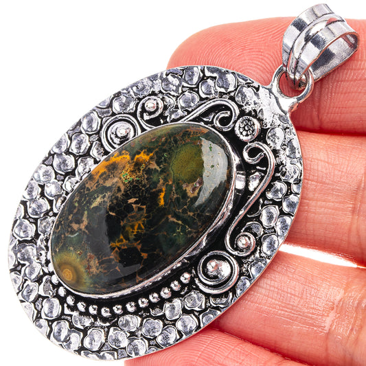 Oval ocean jasper pendant with bezel setting and decorative German silver border
