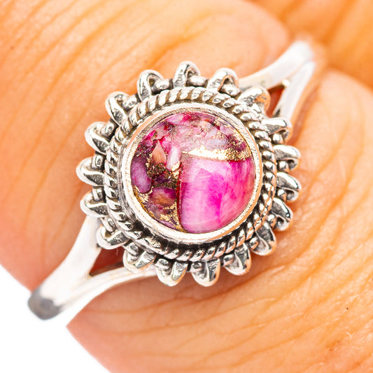 Sterling silver ring with pink oval cabochon and ornate flower border