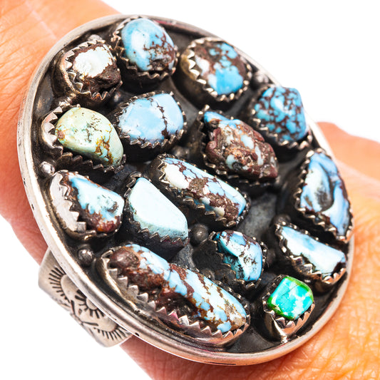 Turquoise oval-stone sterling silver ring with ornate bezel and green accent stone