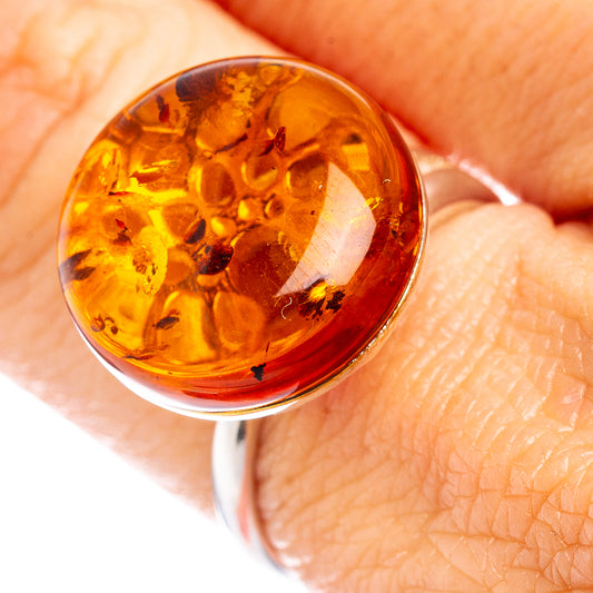 Round amber cabochon sterling silver adjustable ring with warm honey-orange interior