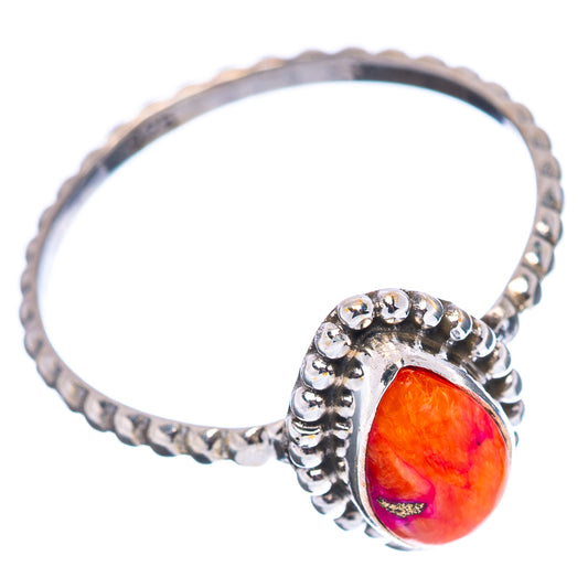 Sterling silver ring with round bead band and orange oval gemstone on side profile