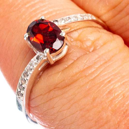 Sterling silver ring with red round center stone and cubic zirconia halo, size 8