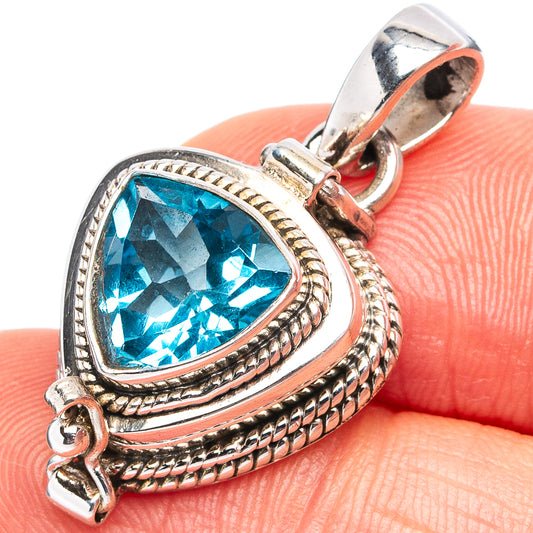 Sterling silver blue topaz teardrop pendant with rope frame and clasped bail, close-up
