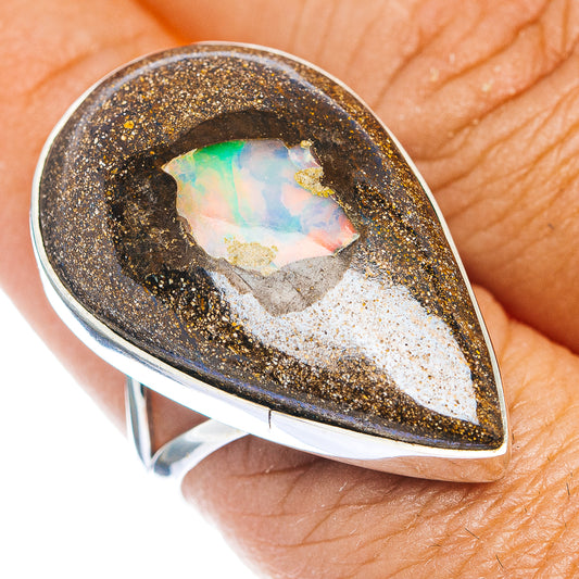Sterling silver teardrop opal ring with iridescent center in gold speckled bezel