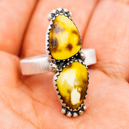Adjustable sterling silver ring with one top and one bottom oval yellow stone