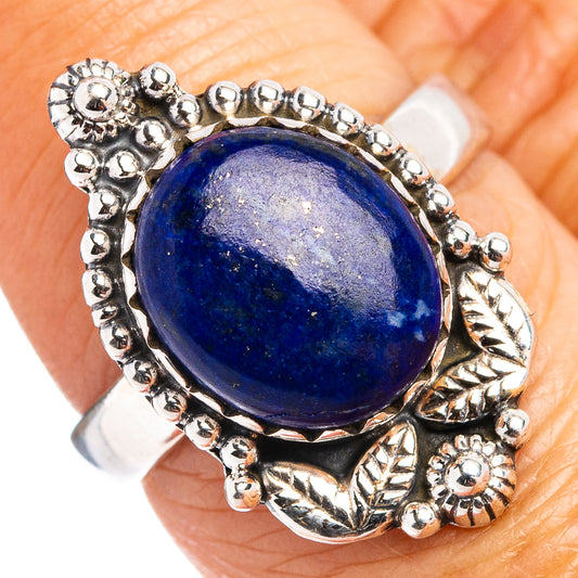 Sterling silver ring with oval blue lapis cabochon and beaded floral bezel setting