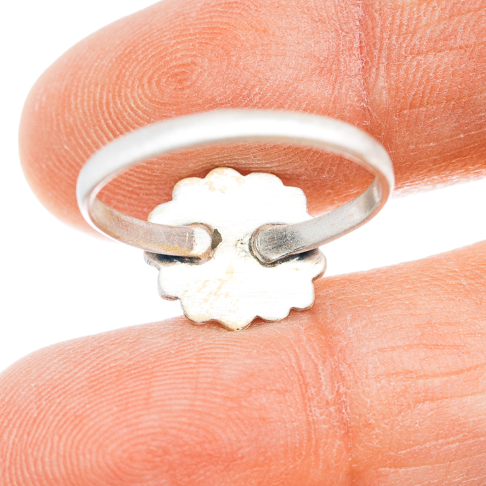 Sterling silver ring band with floral cutout design on underside