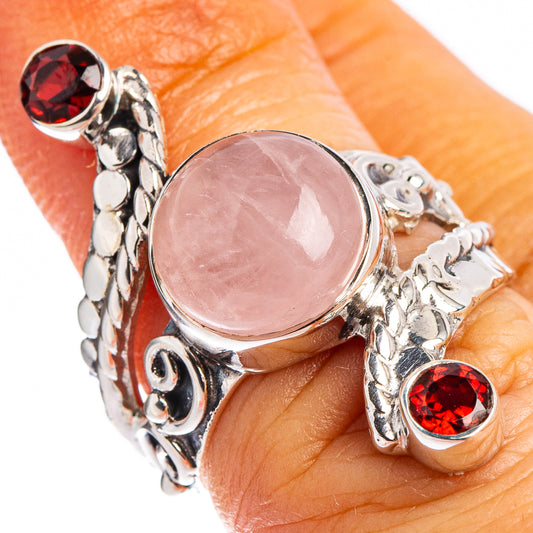 Sterling silver ring with oval rose quartz and two red bezel gemstones, filigree