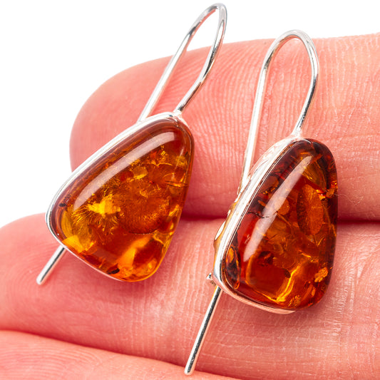 Close-up of amber teardrop earrings with .925 sterling silver hooks