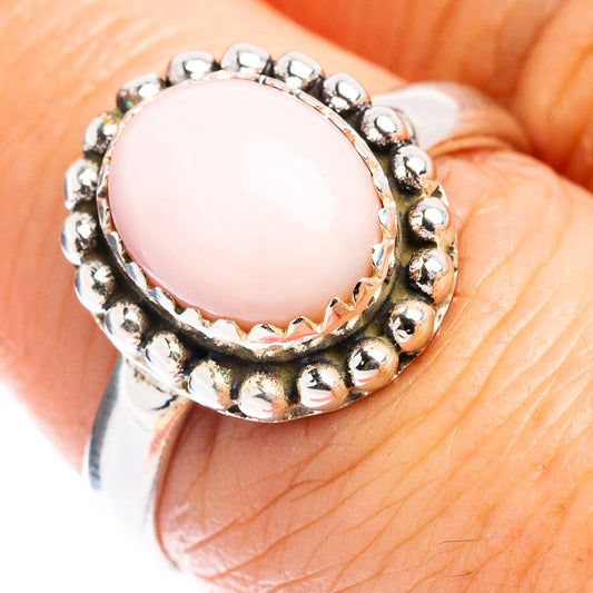 Sterling silver ring with round bead bezel and glossy pink opal centerpiece