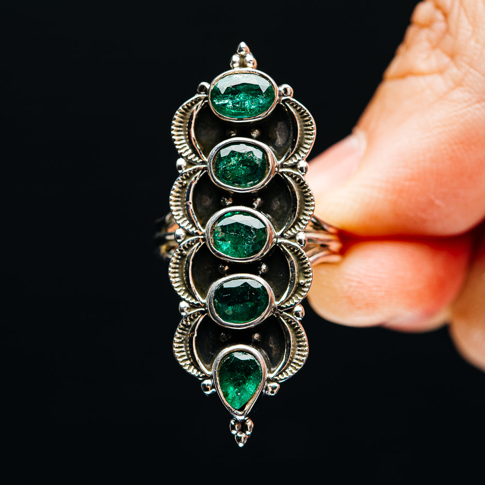 Sterling silver five-stone ring with oval green emeralds in raised halo bezels