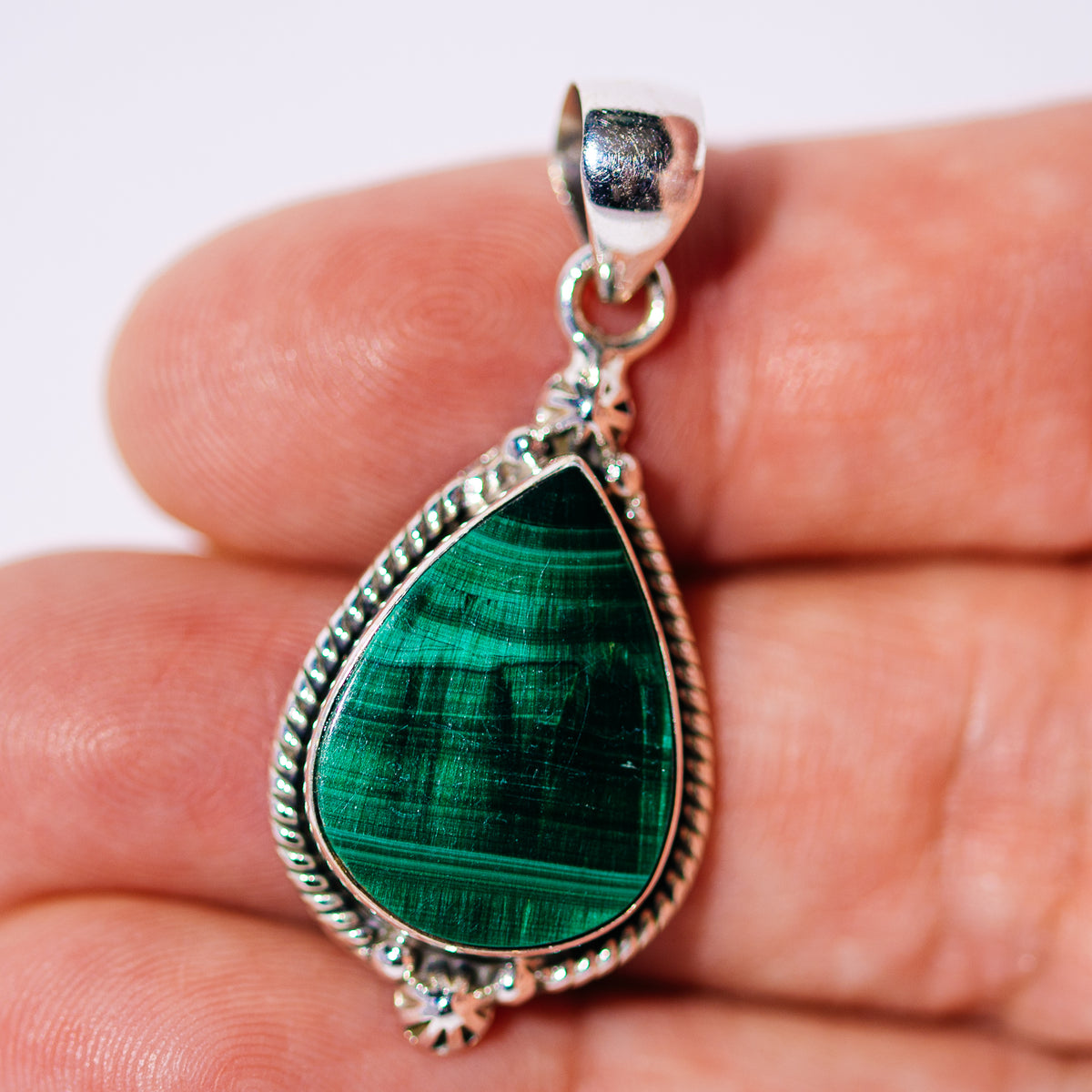 Malachite teardrop pendant in a sterling silver rope-edged setting