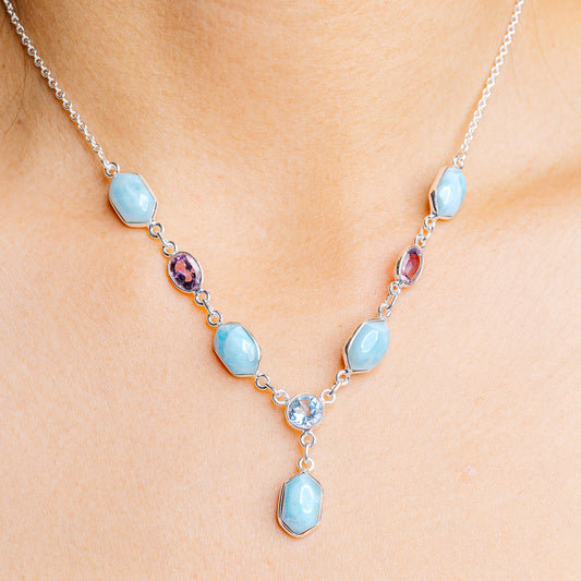 Sterling silver gemstone necklace with light blue drop links and a purple accent