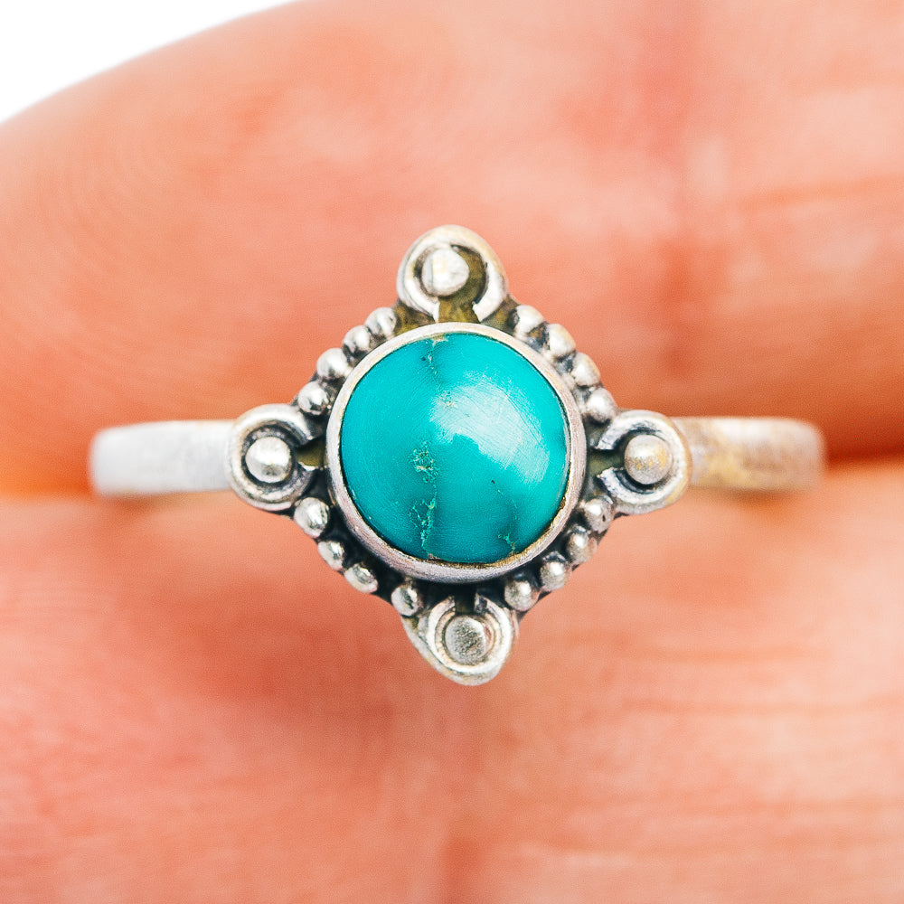 Turquoise oval cabochon sterling silver ring with openwork border and bead details