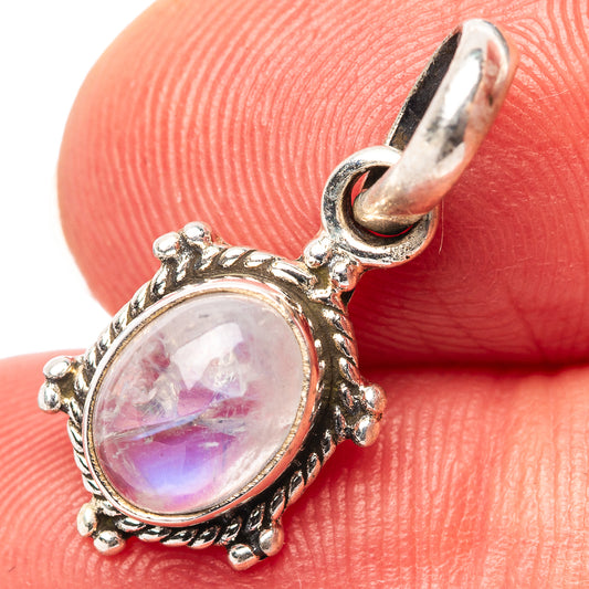 Oval rainbow moonstone pendant in .925 sterling silver ornate bezel with loop bail